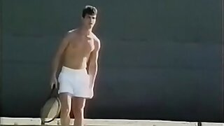 Tennis player likes to loosen his penis stiff muscles after excercises with ball shooter machine and drop his load on his tennis racket